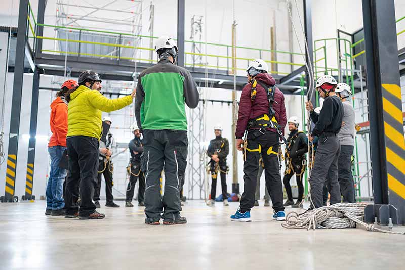 Mechanic checks car undercarriage in GMG-compliant noise-controlled workshop