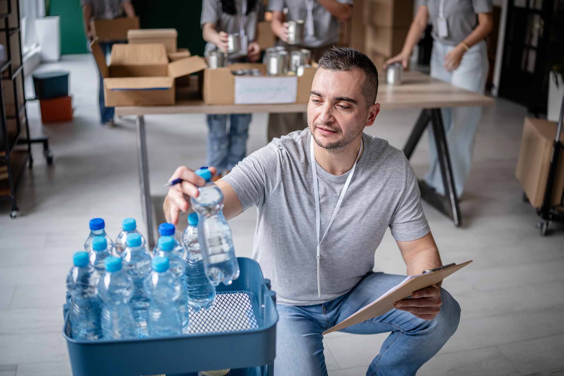 Technician spray painting car with GMG's EHS-compliant collision repair solutions