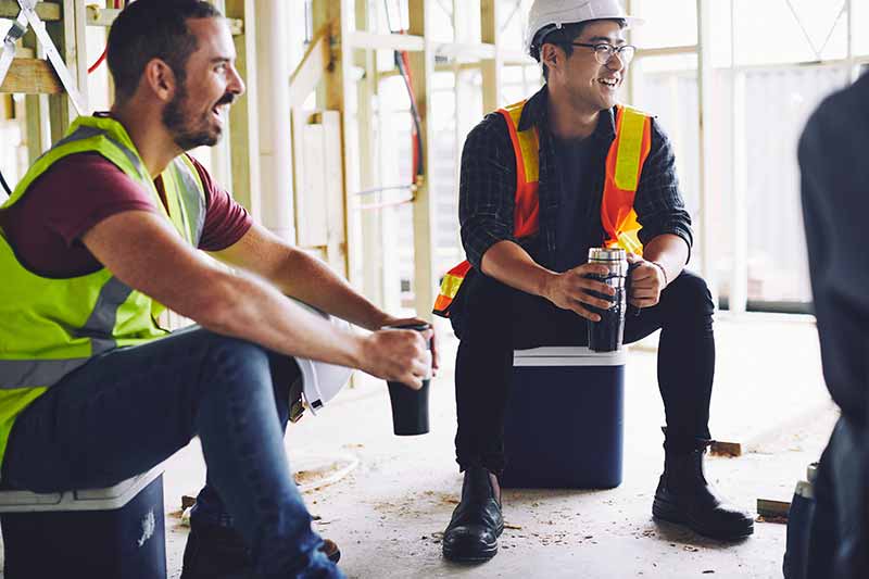 Mechanic checks car undercarriage in GMG-compliant noise-controlled workshop