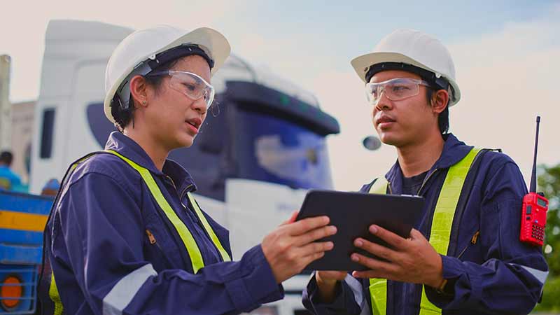 Mechanic responsibly refilling fluids, mindful of GMG's hazardous material protocols