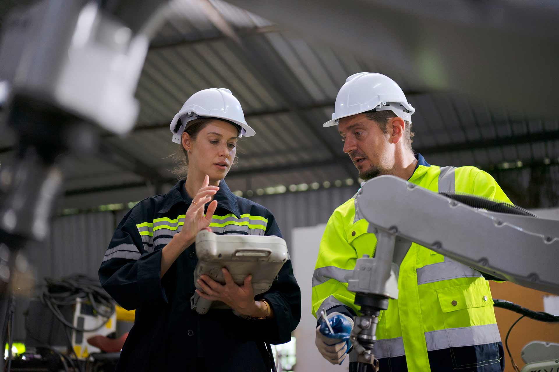 Technician spray painting car with GMG's EHS-compliant collision repair solutions