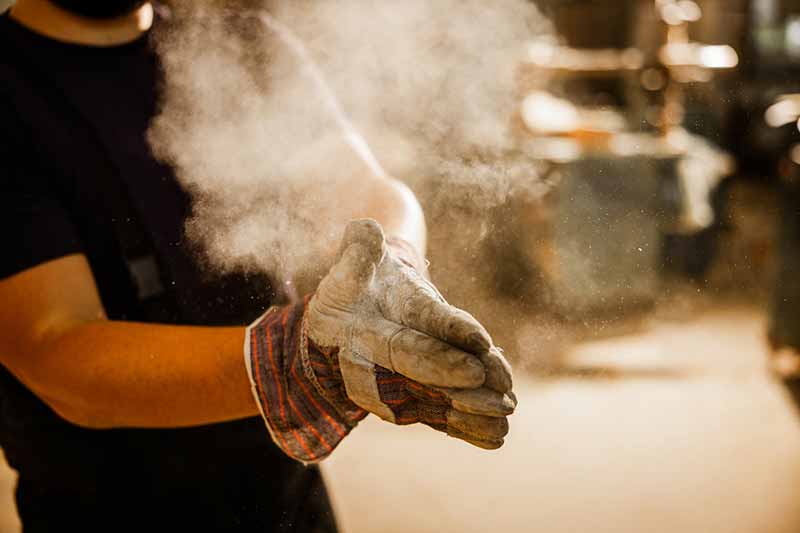EHS-trained welder practicing fire prevention in a collision repair shop