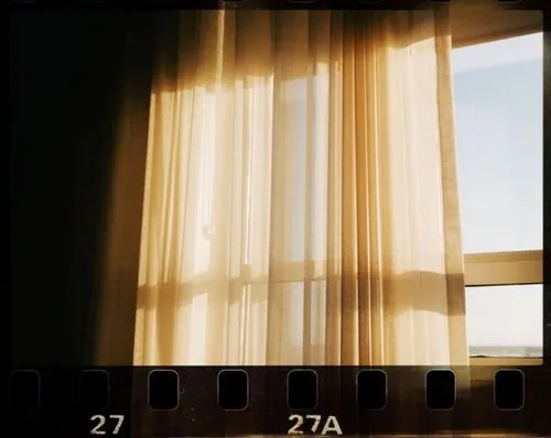 Film FX by VSCO photo edit with 35mm 5a film strip 27 and 27A overlayed on an image of a window and curtain