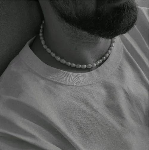 Bearded man's neck wearing pearl necklace edited with black and white VSCO filter B1 by fashion photographer lessaiv