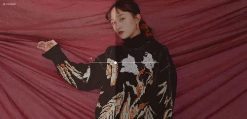 VSCO Exposure tool slider showing darkening of portrait image of woman in a sweater with red background