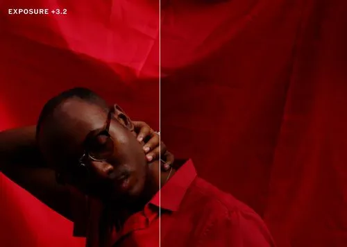 Man in red shirt with red background brightened with photo exposure edits in VSCO photo editor