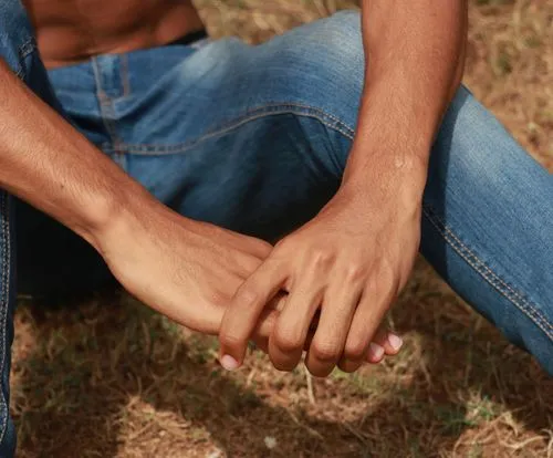 Person sitting with arms on knees wearing blue jeans edited with the VSCO WE5 Pro photo filter