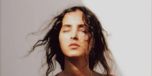 Bloom effect added to photo of a woman with her eyes closed
