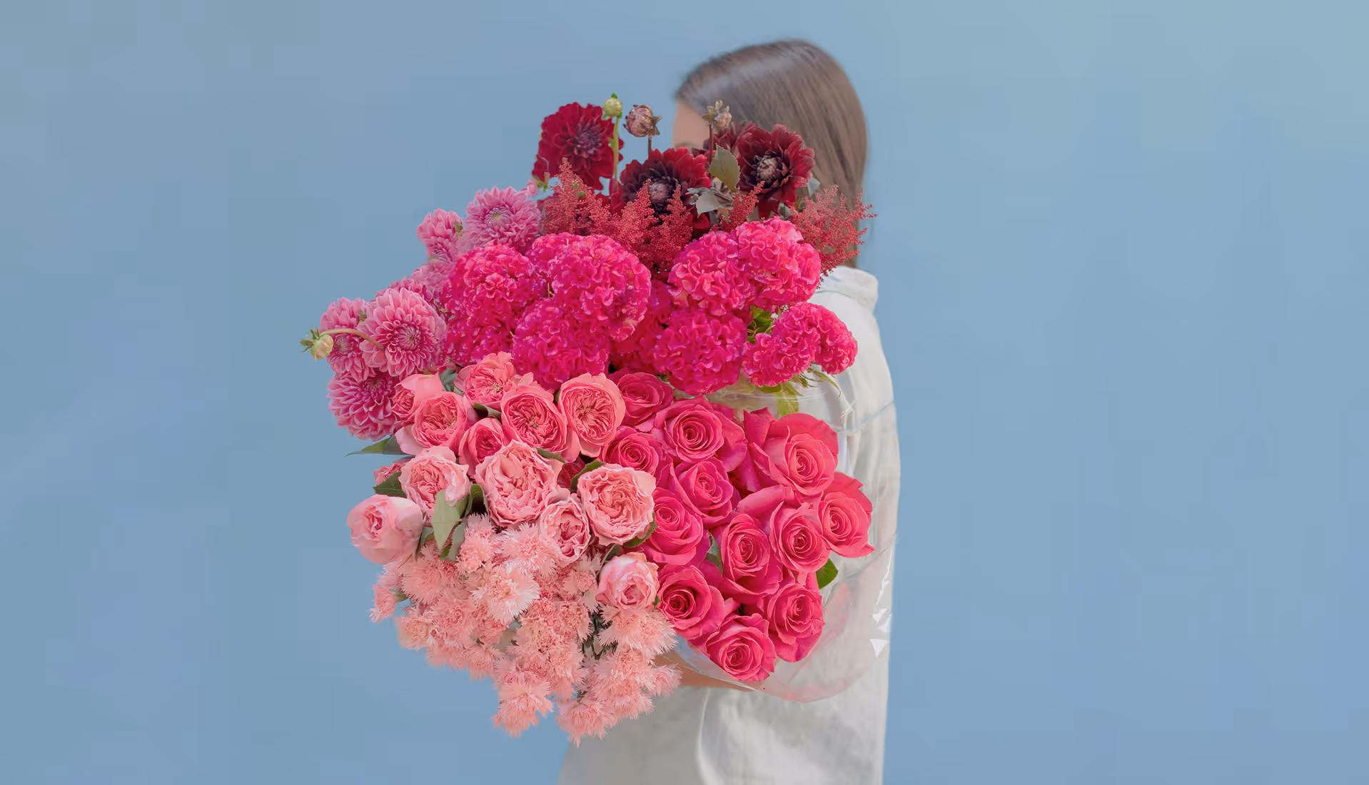 Woman holding large pink flower bouquet