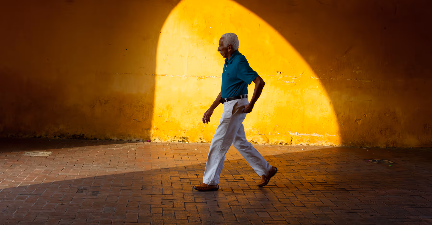 Golden hour filter added to photo of a man walking