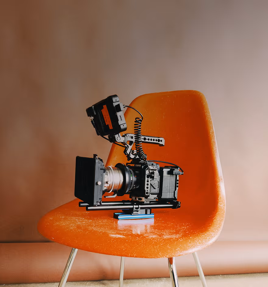 Film filter applied to photo of an orange chair with a camera on it