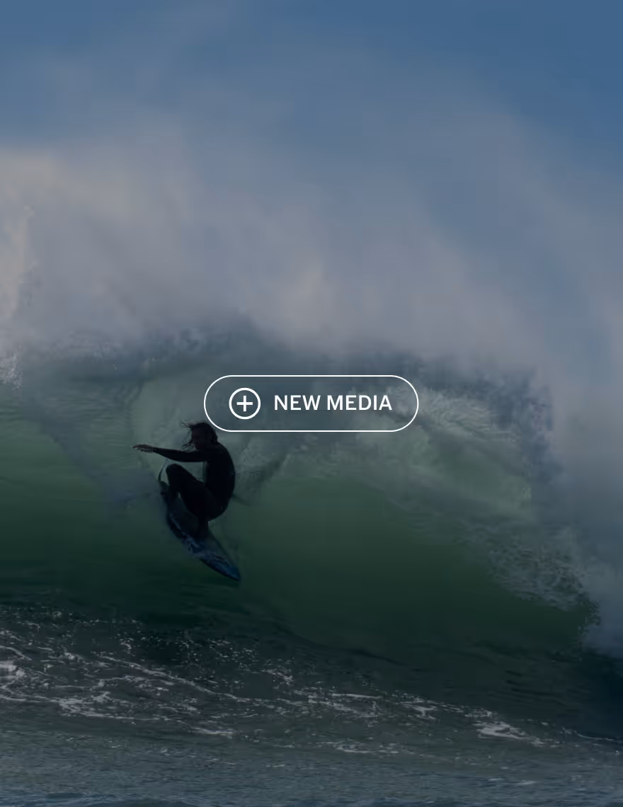 New Media button over a video still of a surfer in a wave