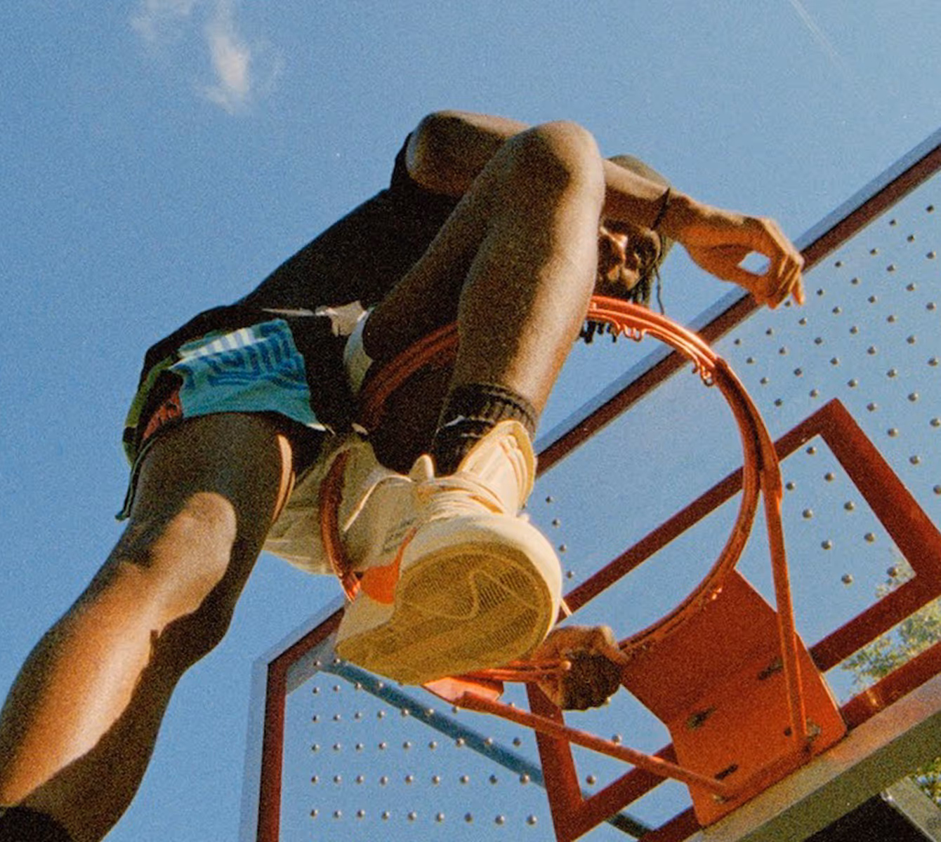 Cropped video still of basketball player on top of hoop