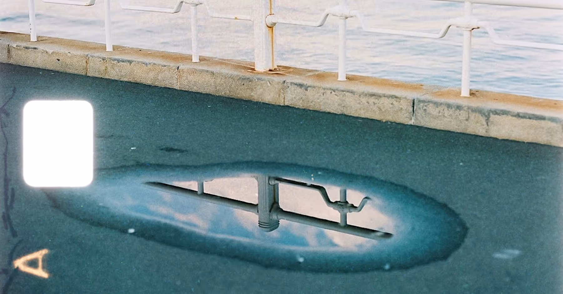 8mm 2 film frame overlay on image of a puddle