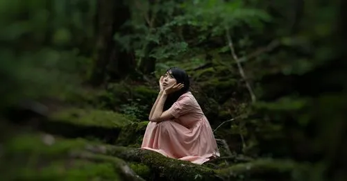 Background blurred behind woman in a forest