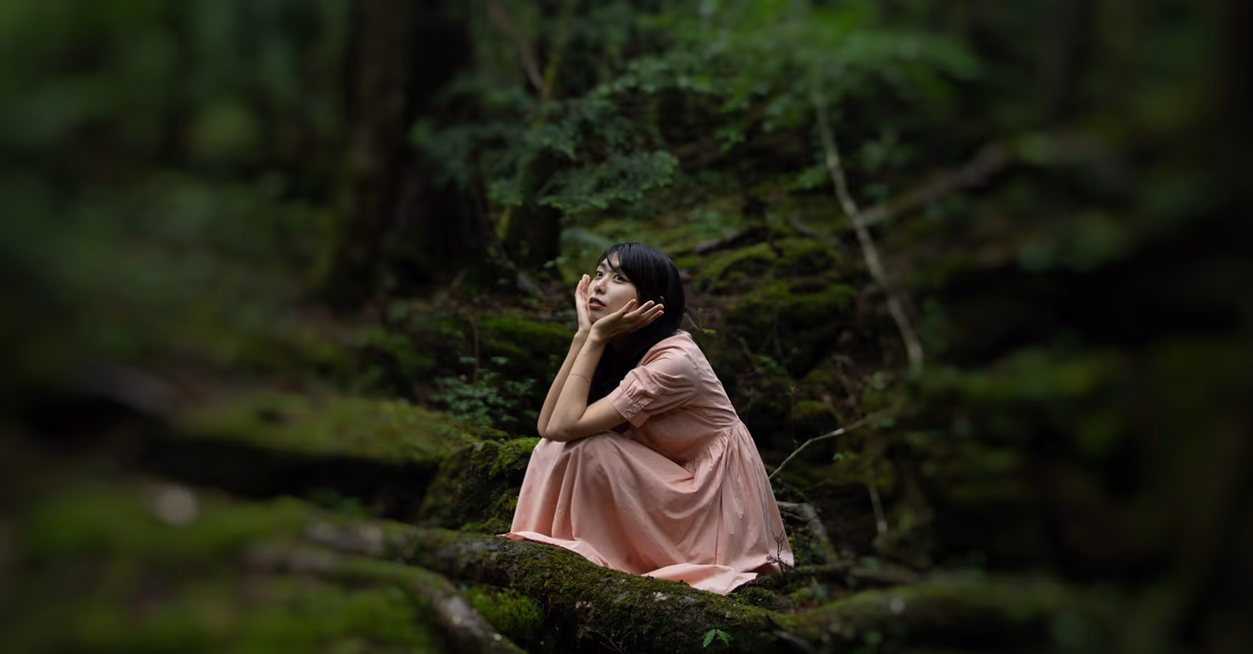 Background blurred behind woman in a forest