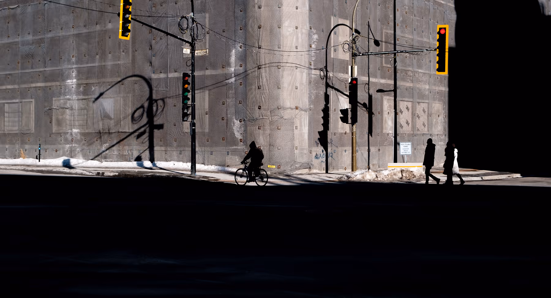 Muted video still of someone riding a bike through intersection