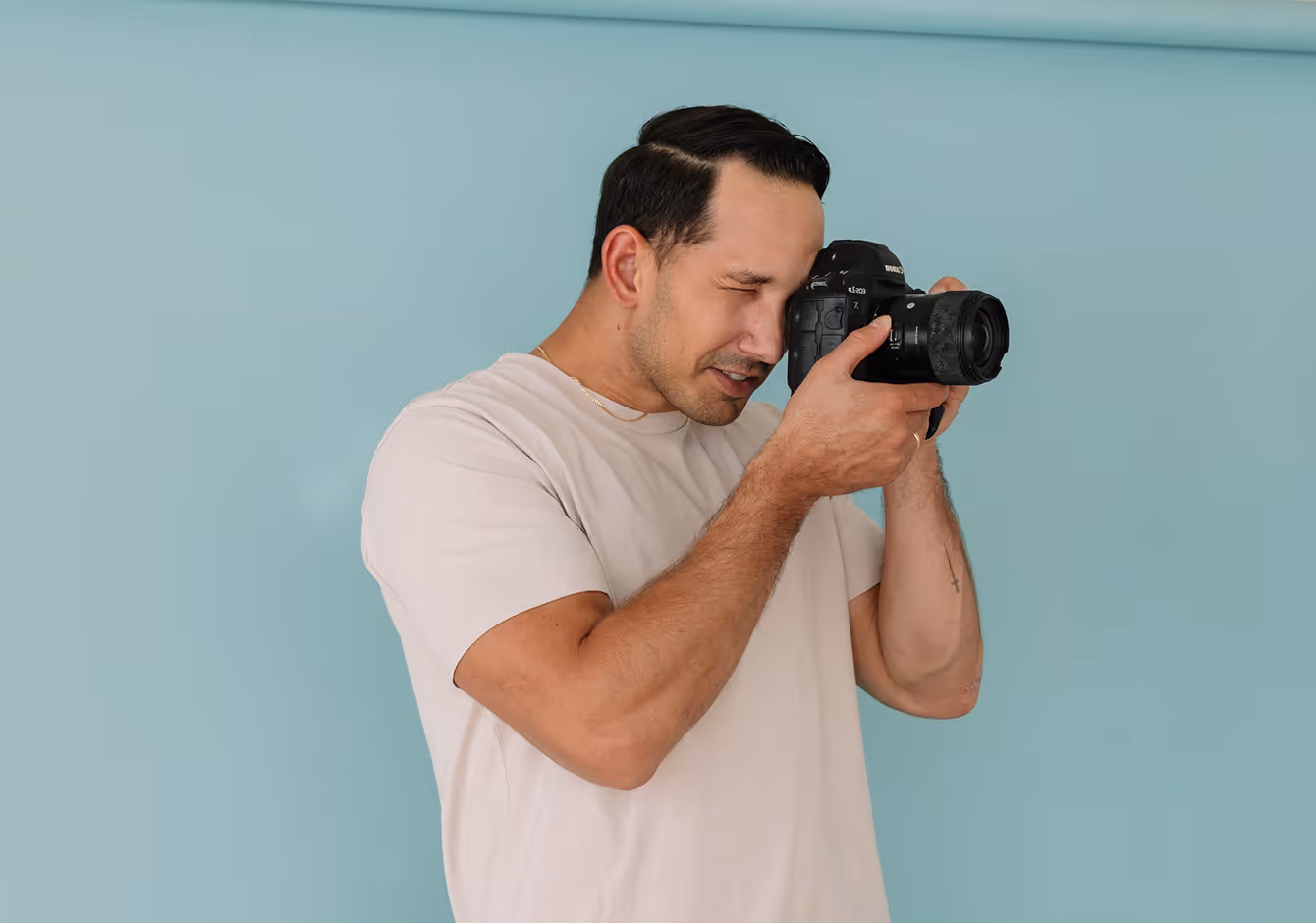 Photographer using camera and studio management software