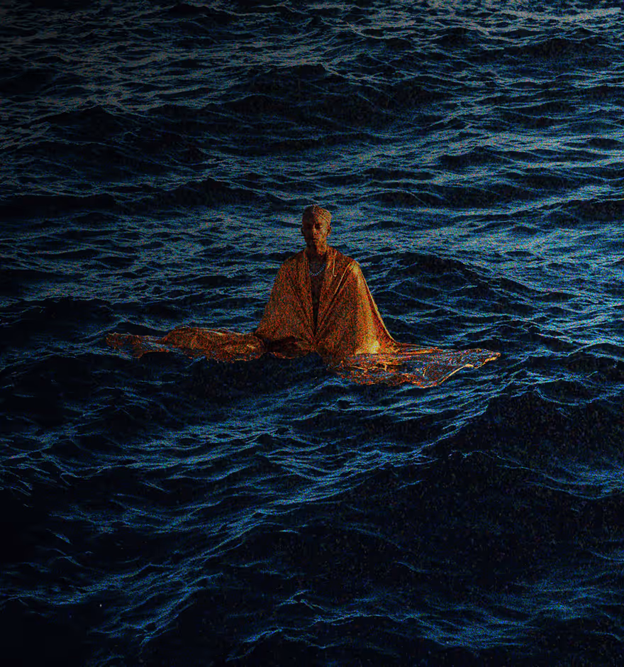 Person wrapped in an orange blanket floating on dark, wavy ocean water at night.