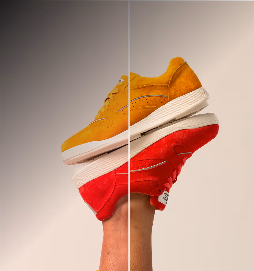 A pair of suede yellow and red sneakers held on one foot, with a line splitting before and after skin tone adjustments