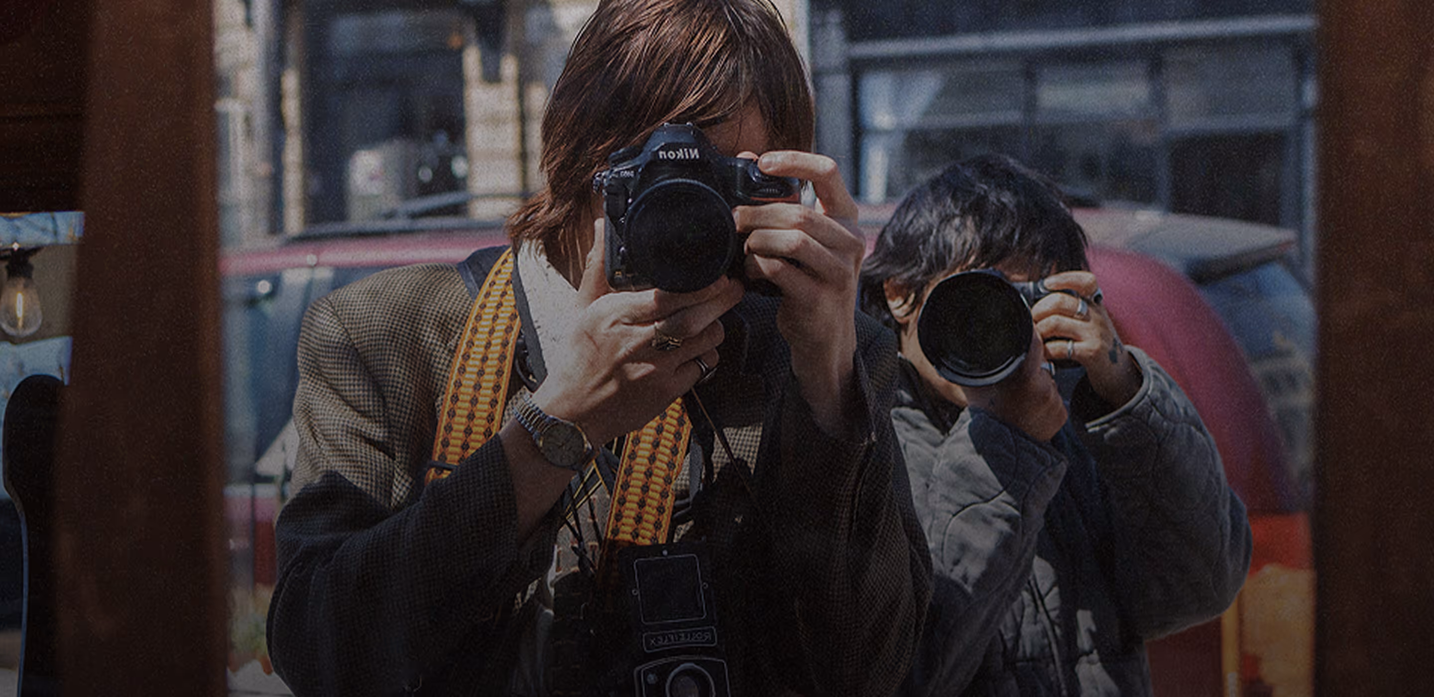 Photographers taking photos in window reflection