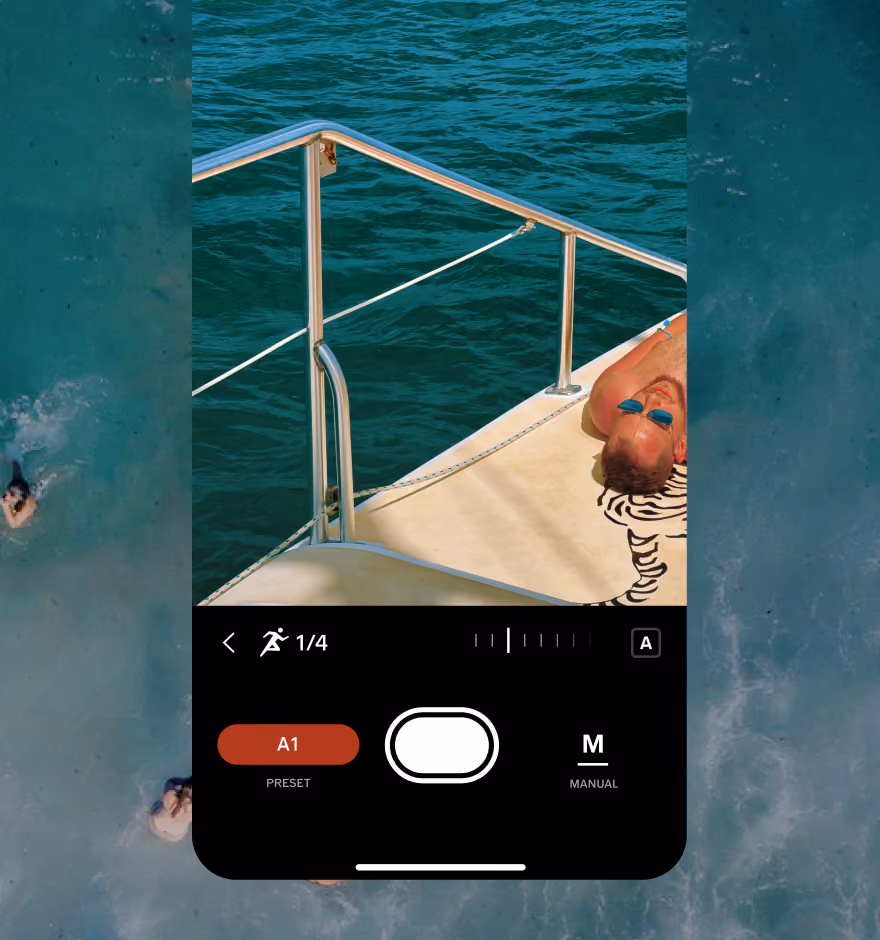 Manual camera app screen with shutter speed slider adjustment settings showing a man wearing blue sunglasses lying on a boat deck by the water.