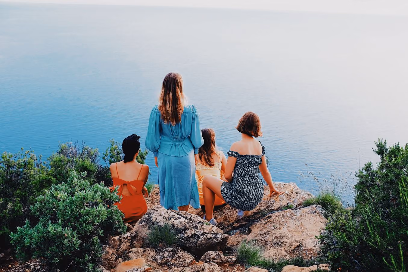 Four people on a clifftop above the sea, HB3 PRO preset applied