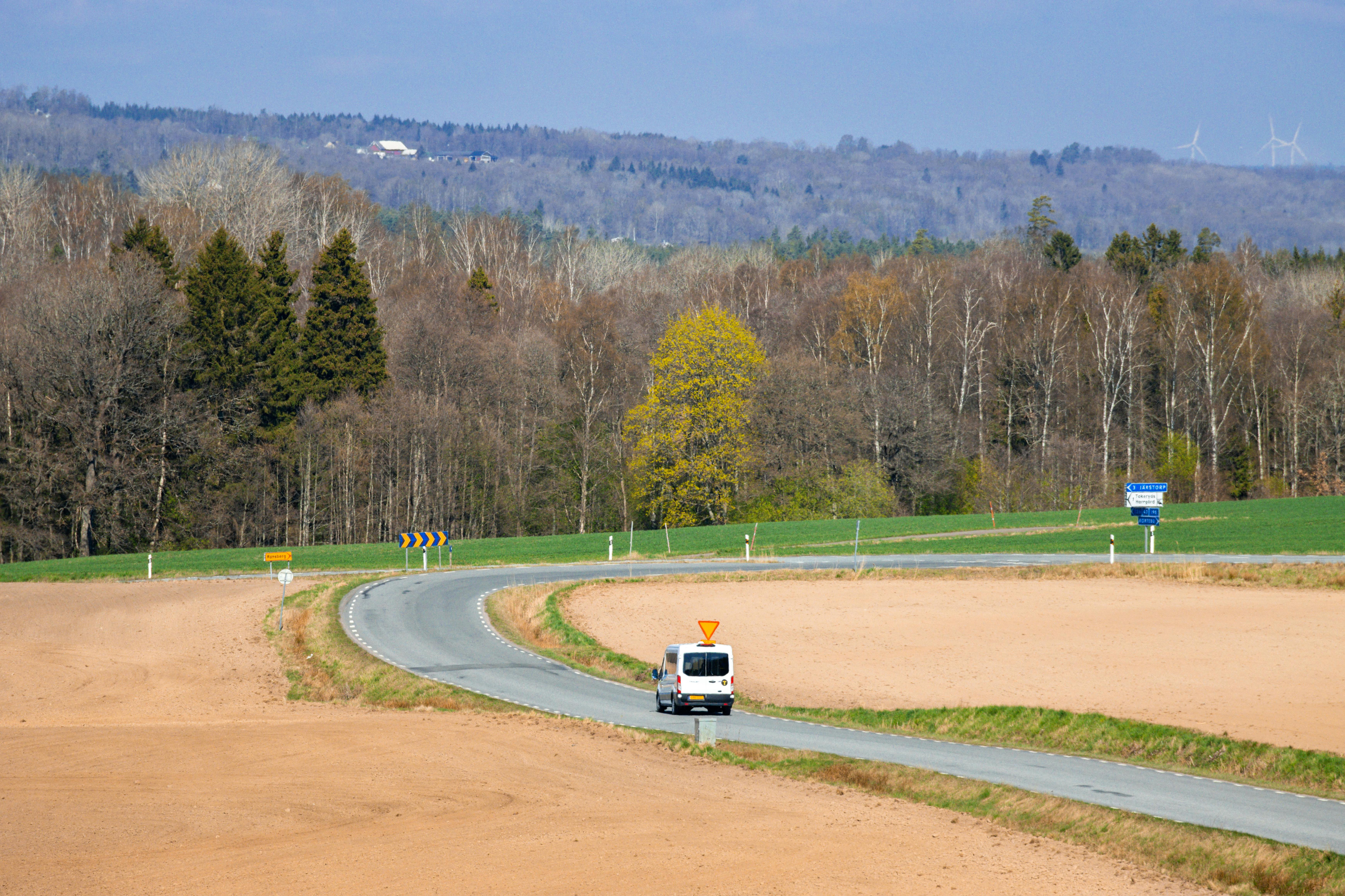 Serene countryside view with a winding road in Jönköping, showcasing a tranquil rural landscape.