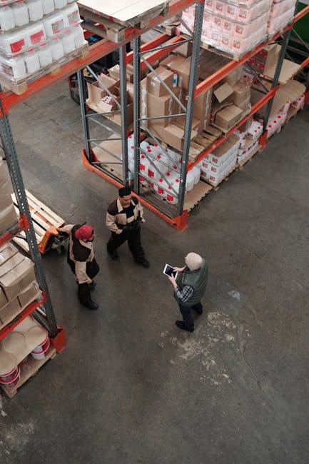 Workers discuss logistics in a busy warehouse setting, enhancing teamwork and efficiency.