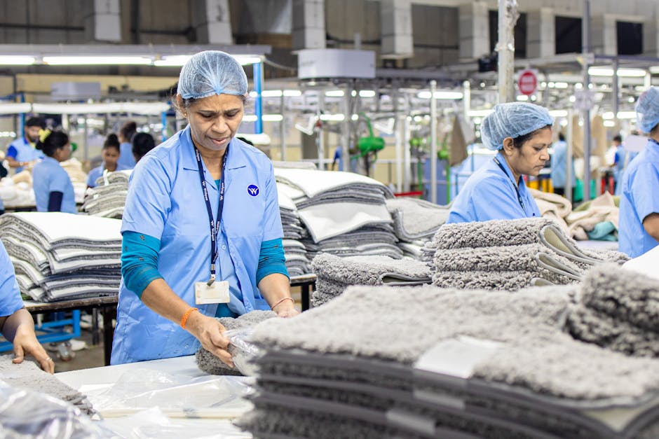 Focused textile factory workers organizing materials efficiently indoors.
