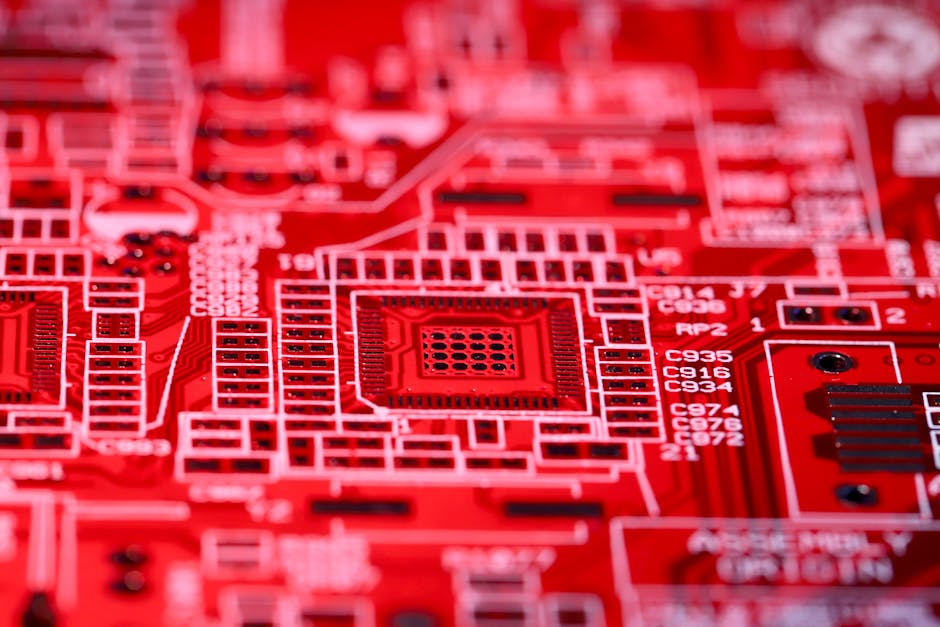 Detailed macro shot of a red circuit board showcasing electronic components and intricate patterns.