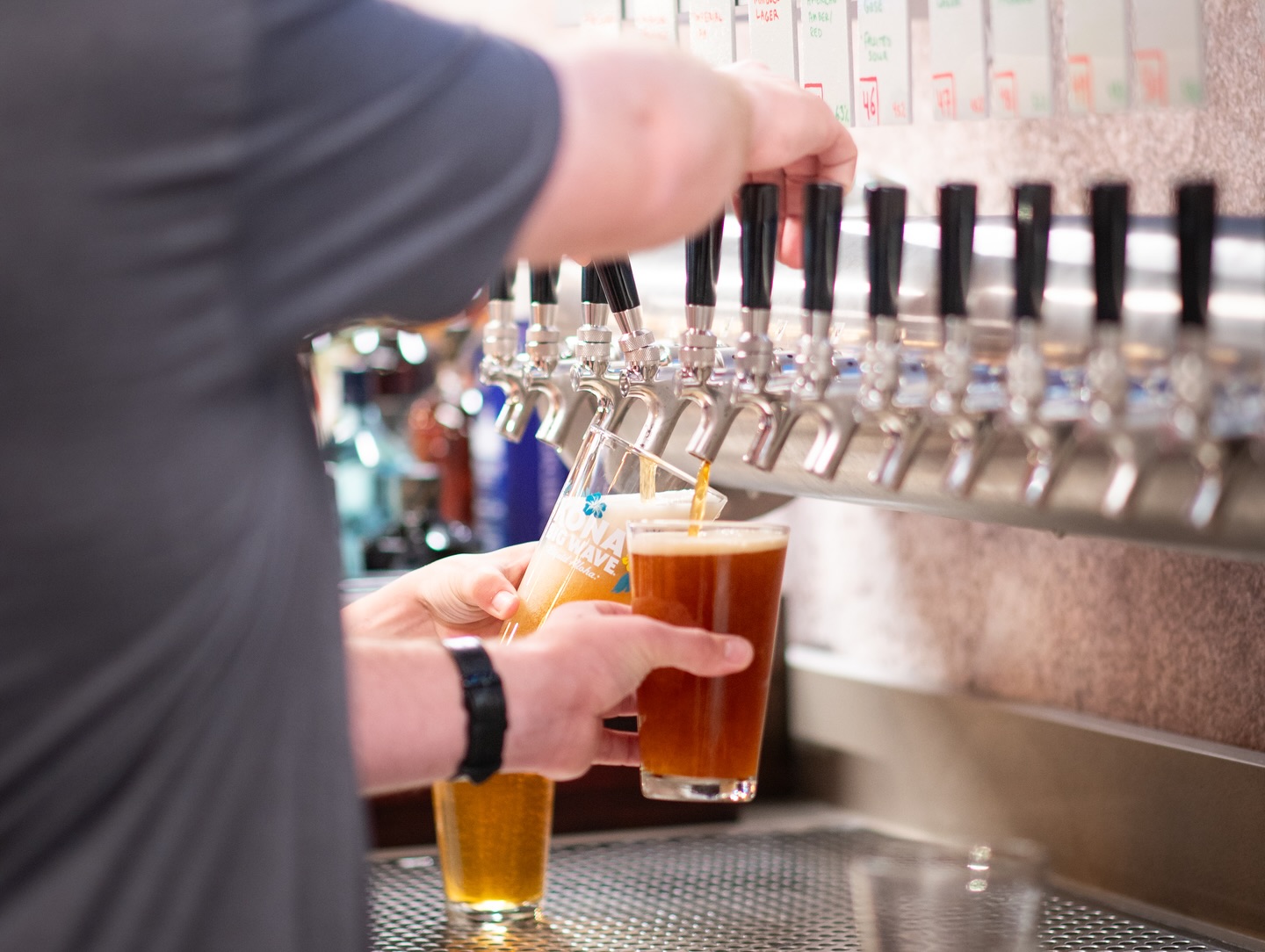 an image of a man pouring beer from a tap at Elicit Brewing Tapstation.