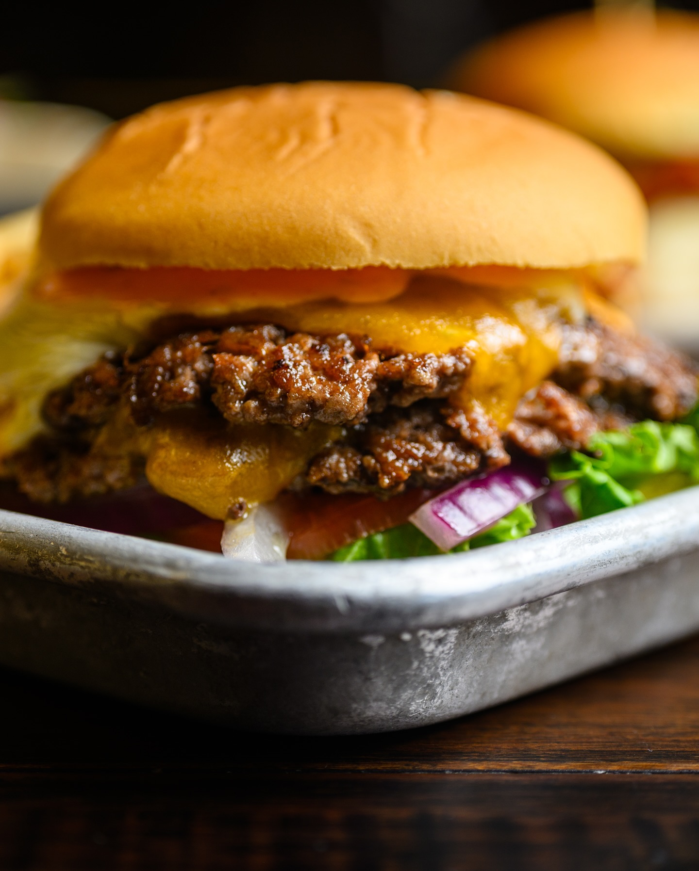 A close-up image of a smash burger at Elicit Brewing.