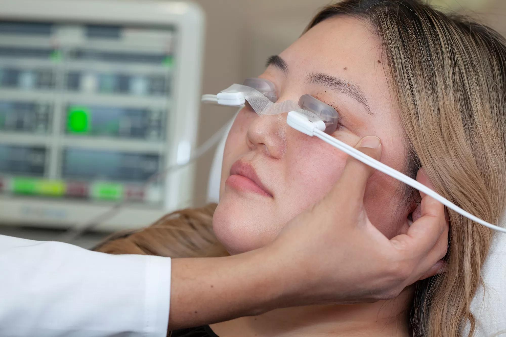 Patient receiving LipiFlow thermal pulsation treatment for meibomian gland dysfunction