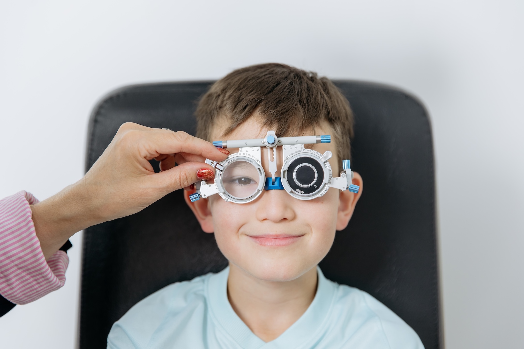 Child having an eye examination as part of a myopia management assessment