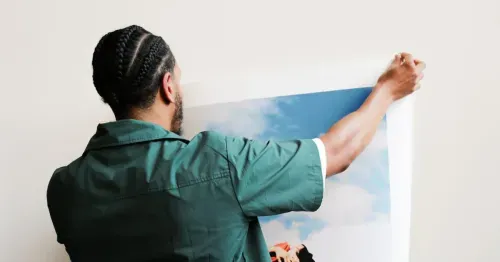 Photographer holding up a licensed photograph print for a brand