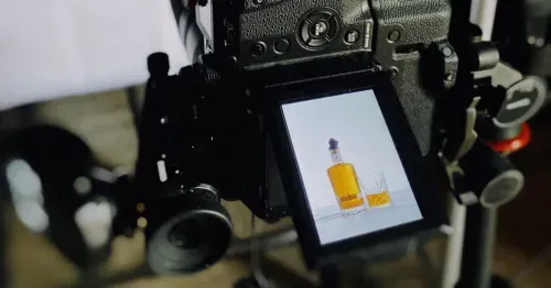 Preview screen of a camera showing product photo of a bottle and glass