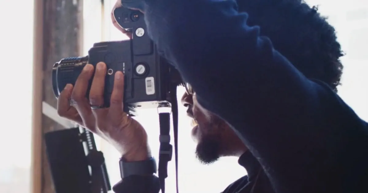 Photographer holding camera photo during professional photoshoot