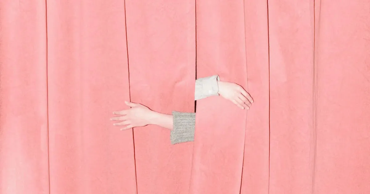 Professional portfolio photo of two hands emerging from behind a pink curtain in opposite directions