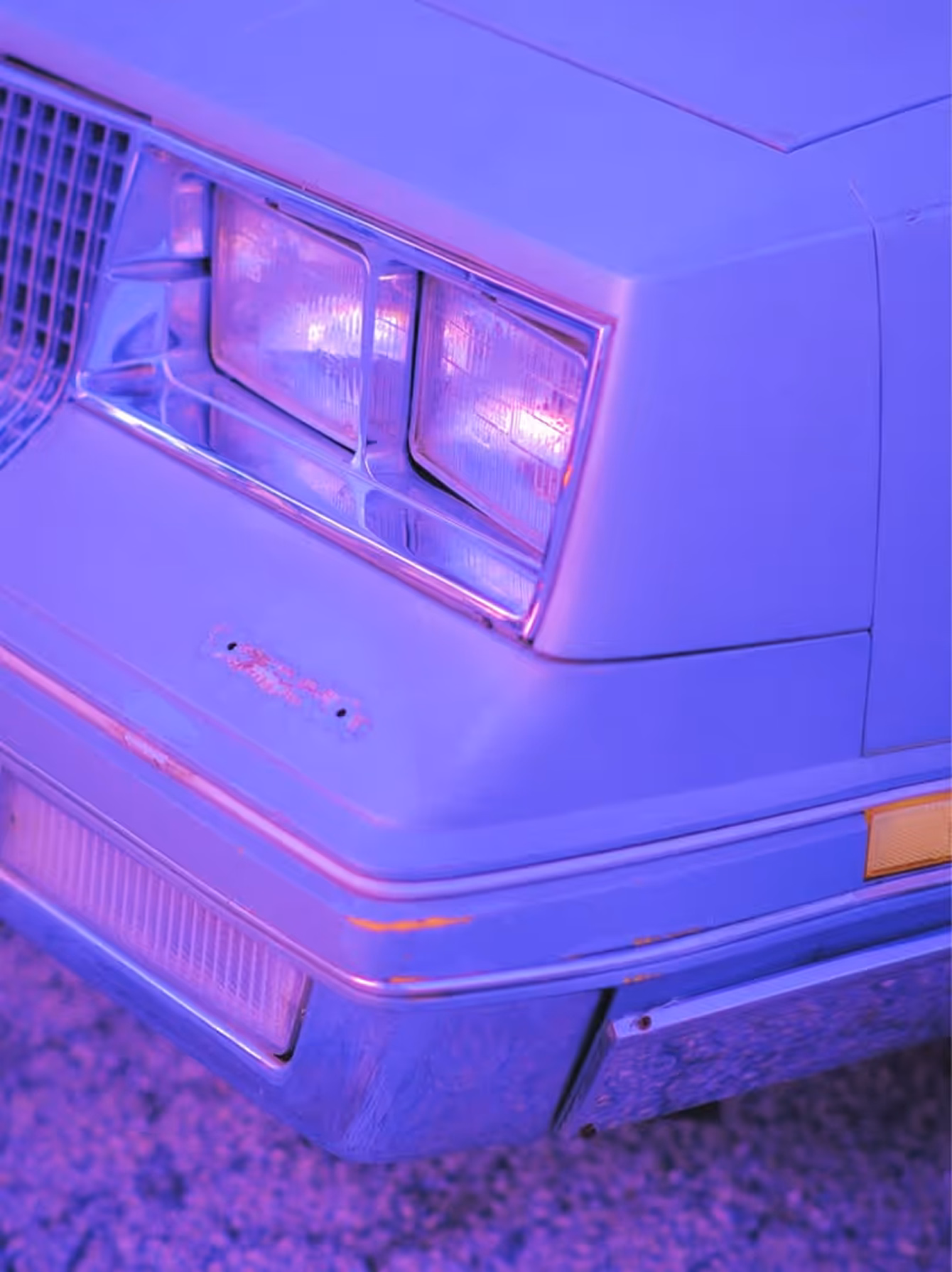 Headlight of vintage card in purple lighting taken by professional photographer Tess Burris