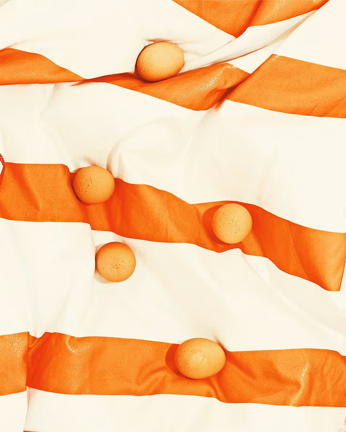 Oranges on a striped cloth by photographer Cody Guilfoyle