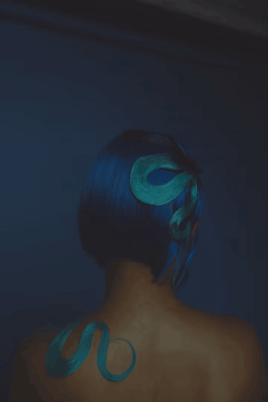 Studio portrait photo of a person facing away with blue hair against a blue backdrop by photographer Deun Ivory