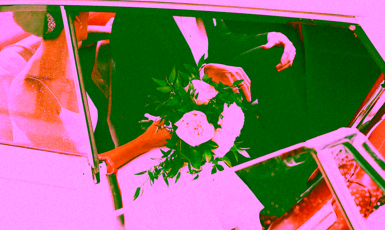 Wedding photo of a couple in a vintage car
