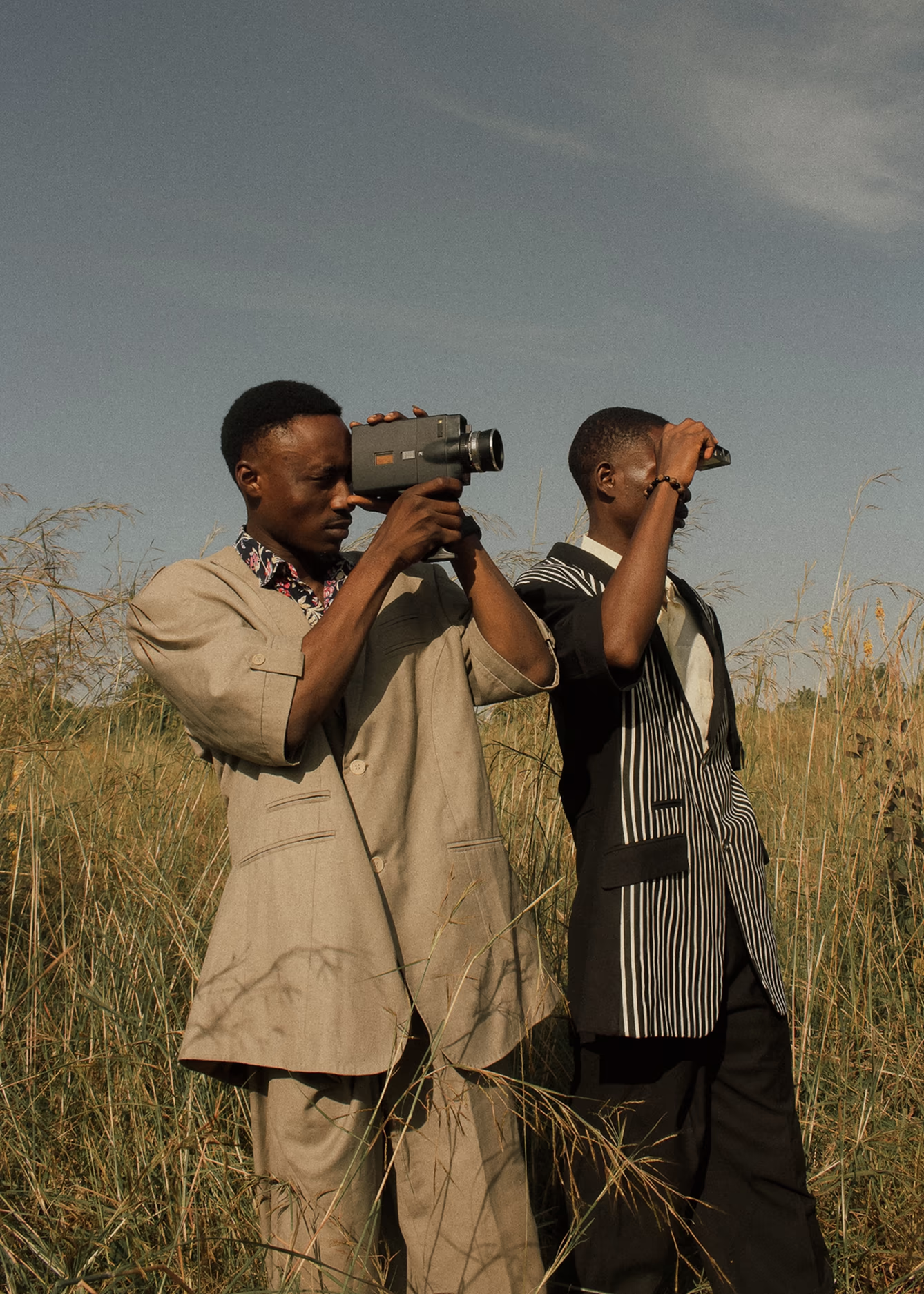 Two videographers in a field