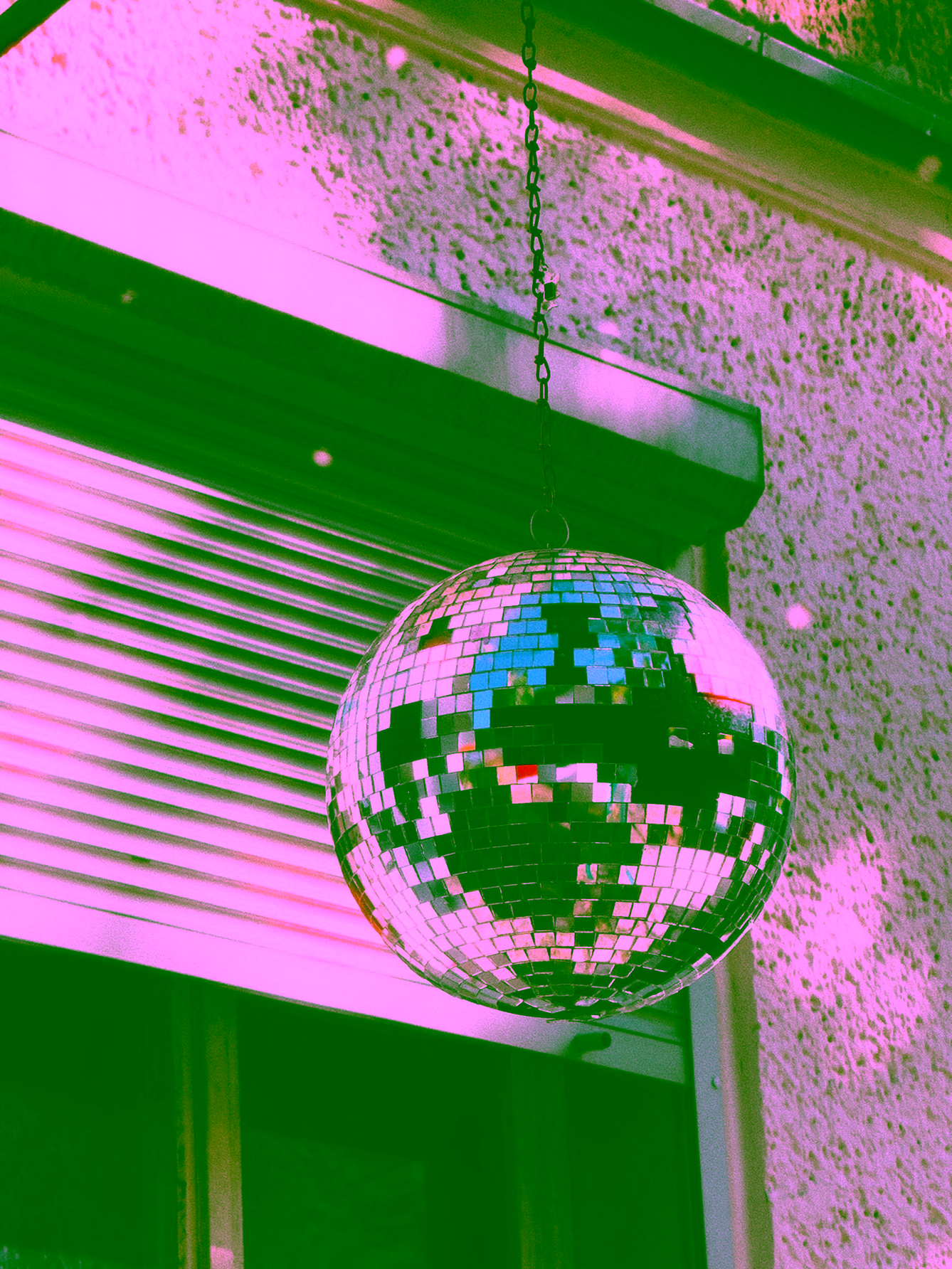 Hanging disco ball in daylight by Kaan Bicen