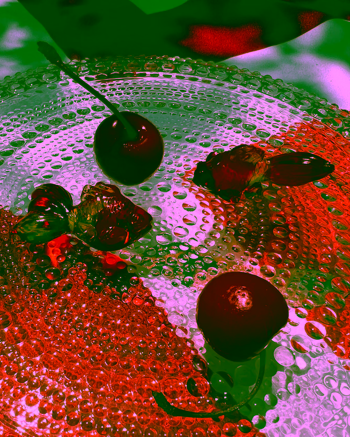 Cherries on glass dish by photographer Yasumi Toyoda