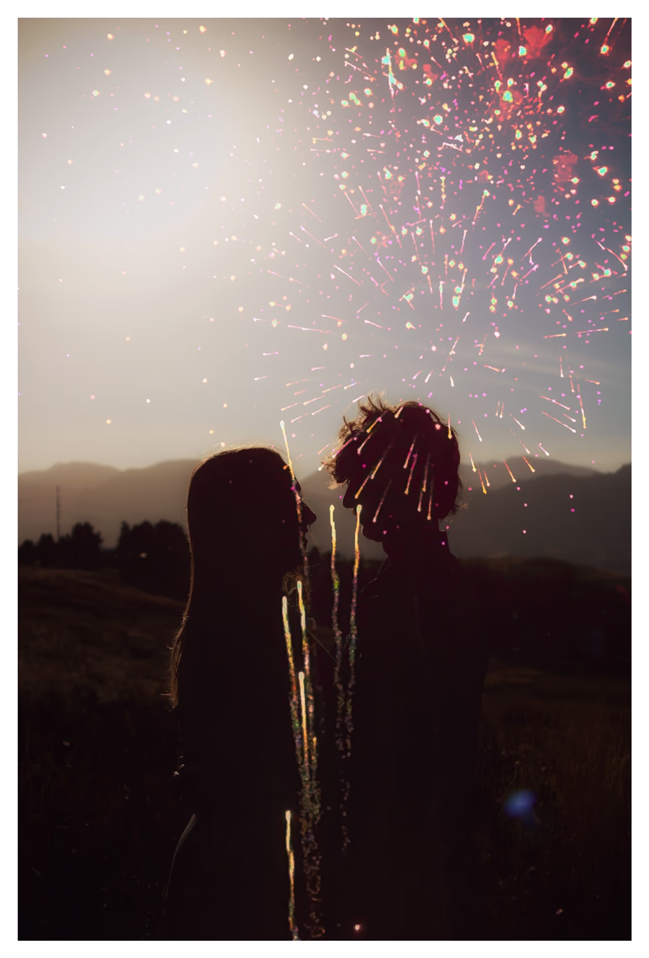 Double exposure of a silhouette of a couple and fireworks by Marin Kirkman