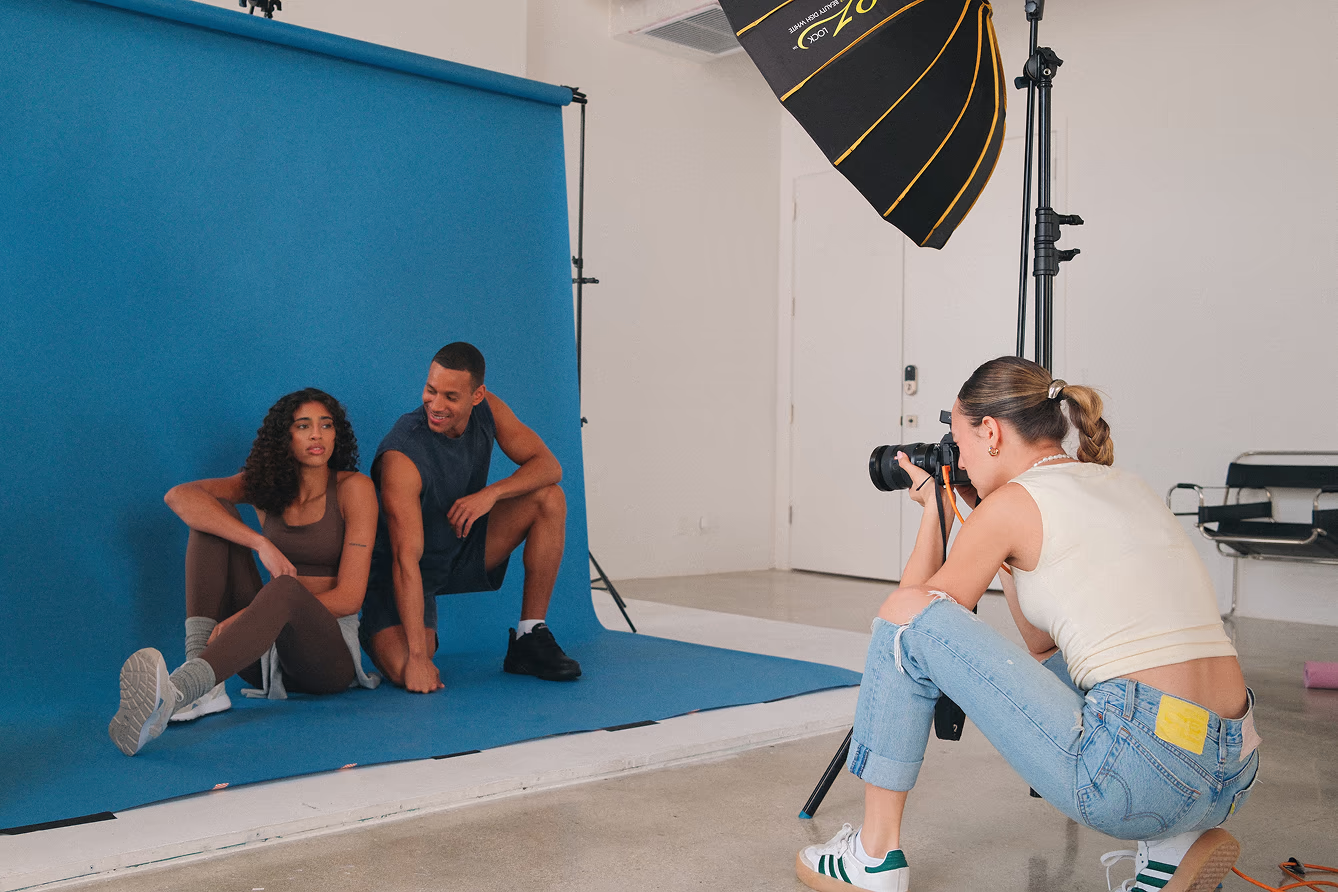 Professional brand photographer taking photos of fitness brand models