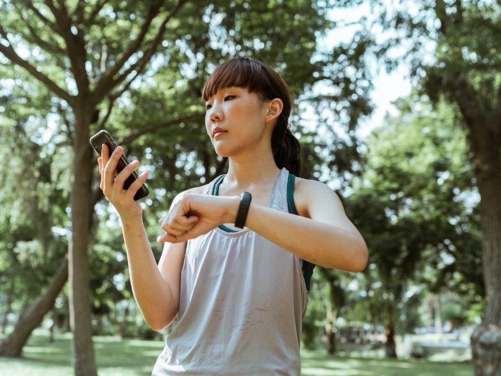 woman reading her step counter on her wrist