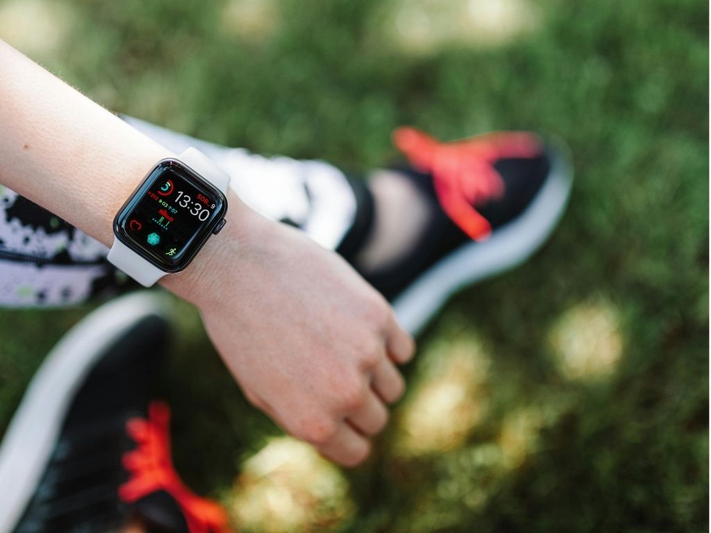 woman reading her apple watch fitness data